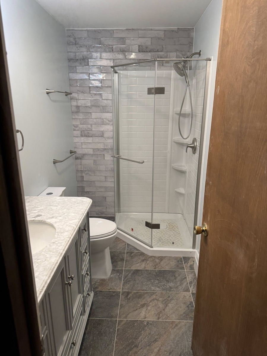 Completed bathroom remodel with tile shower